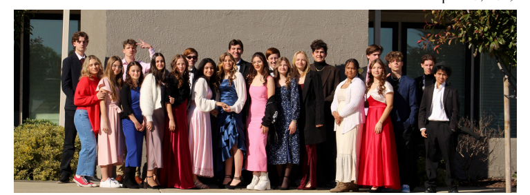 High School students posing for a picture in red carpet clothing.